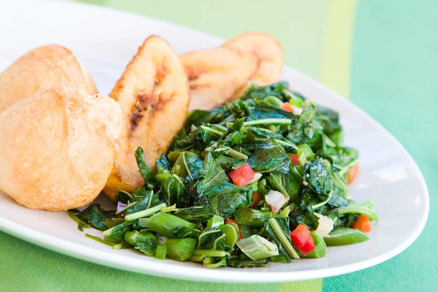 Speciality caribbean dish of callaloo (spinach) served with fried dumplings