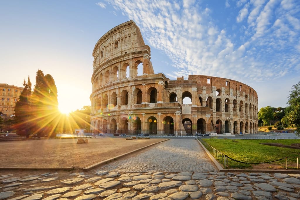 View of Colosseum in Rome and morning sun, Italy, Europe.