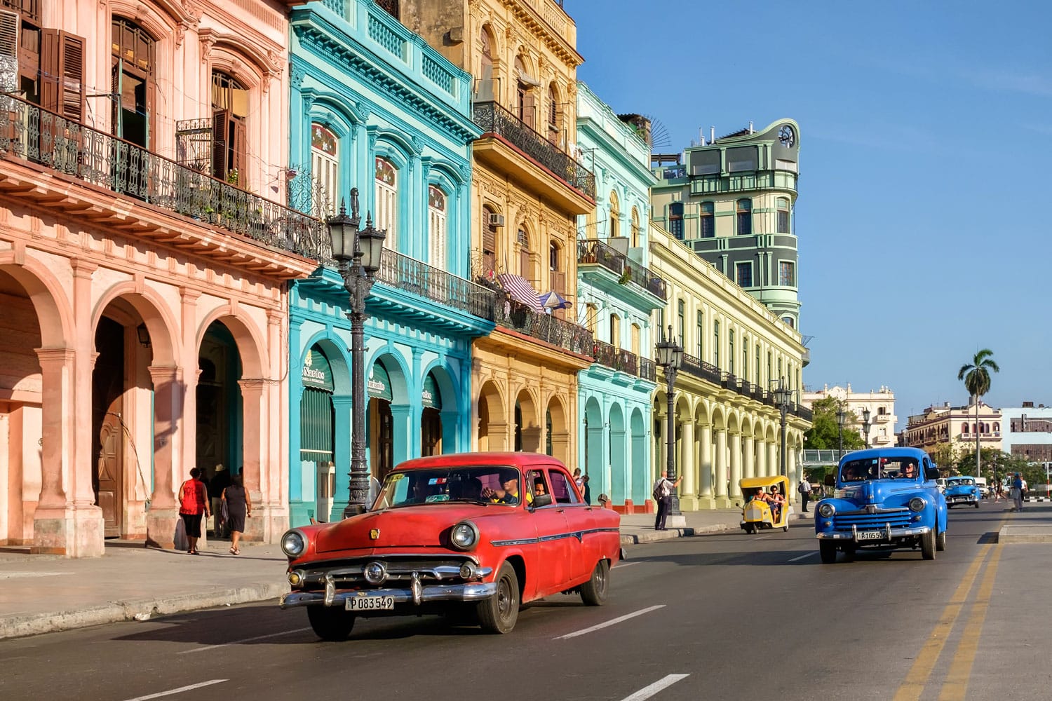 Street scene with colorful buildings and old american car in downtown Havana, Cuba