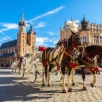Horse carriages at main square in Krakow in a summer day, Poland