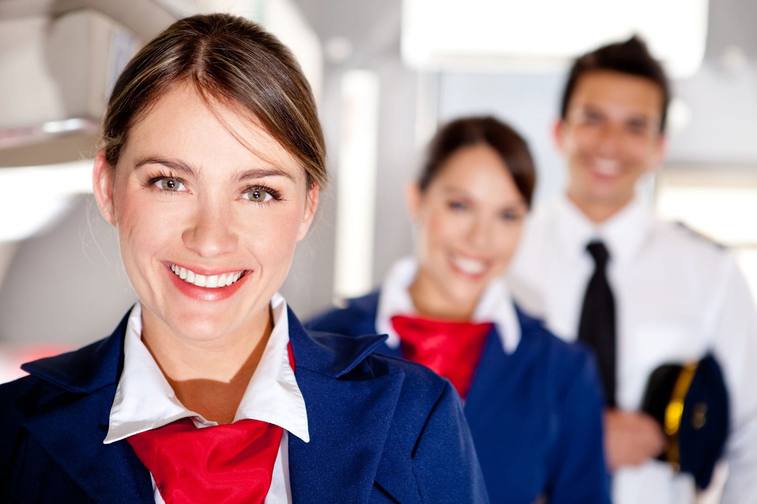 Air hostess with the airplane cabin crew smiling