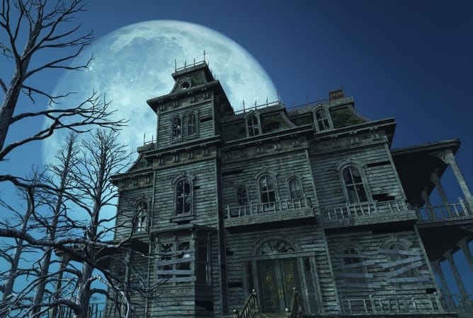 A spooky old haunted house on a moonlit night