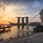 Landscape view of sunrise at Singapore landmark of Merlion and background with Marina Bay Sand building in Singapore