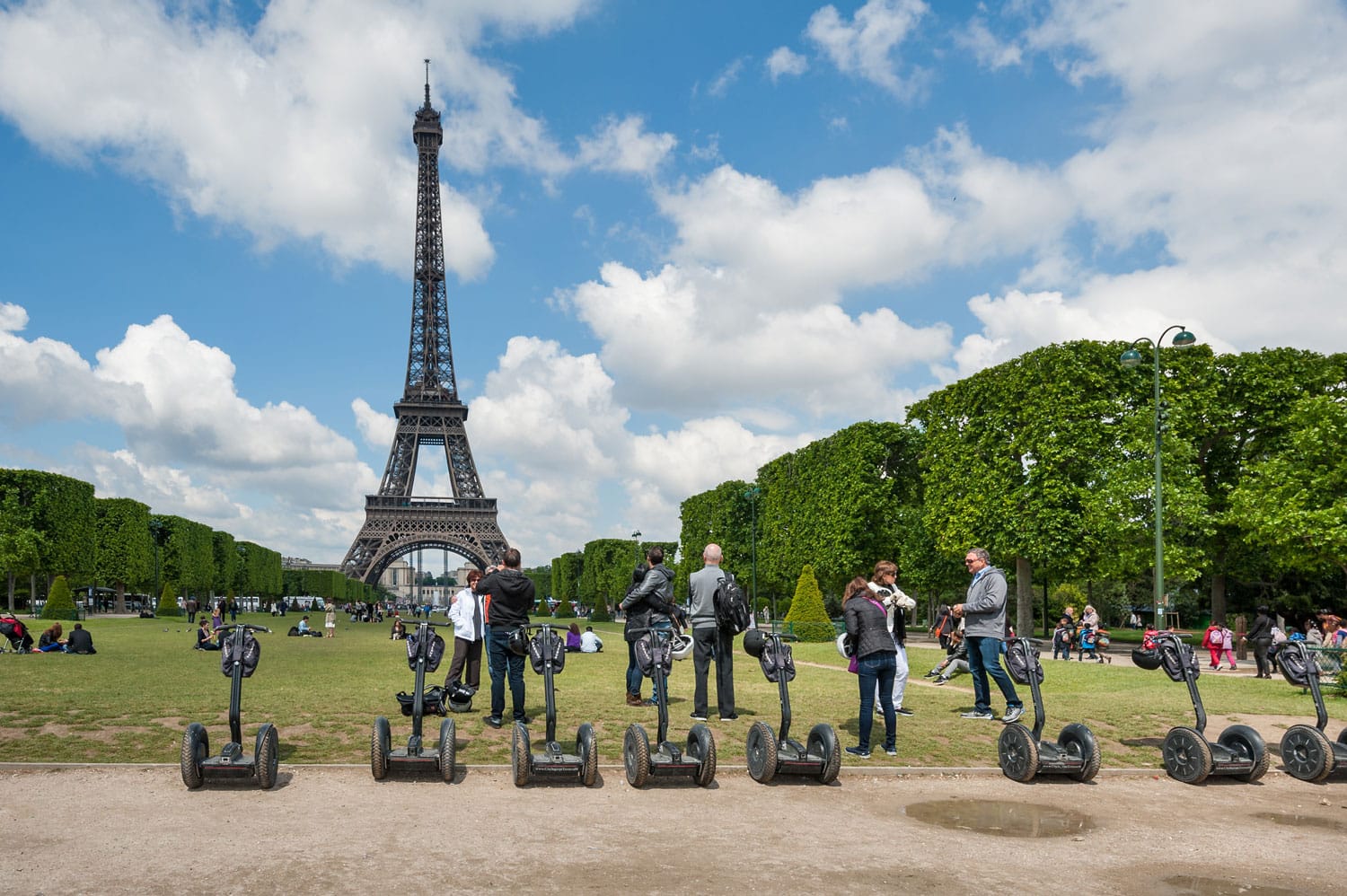 Tourists visiting the city near the Eiffel Tower during their guided Segway tour of Paris