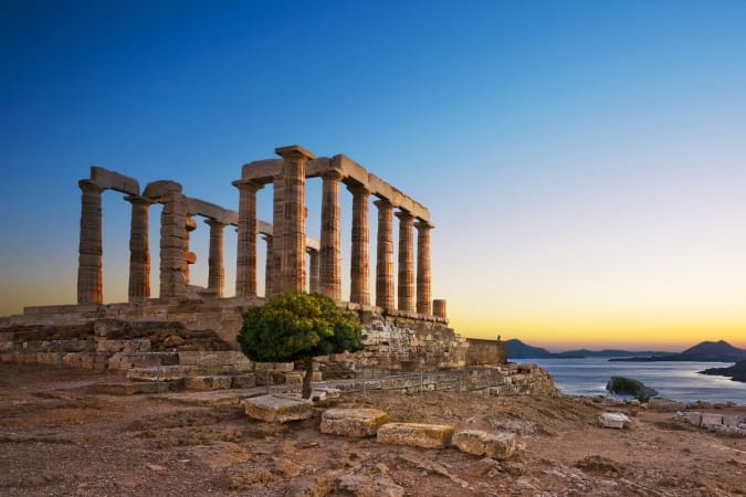Ruins of an ancient Greek temple of Poseidon after sunset