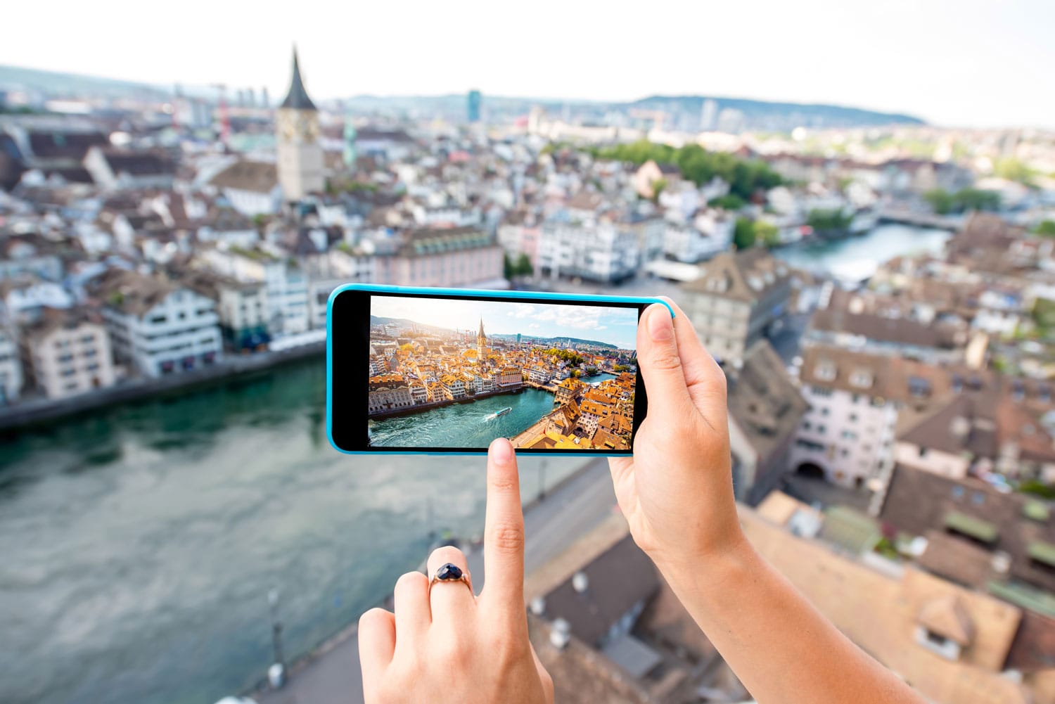 Photographing with smart phone aerial view on Zurich old town in Switzerland