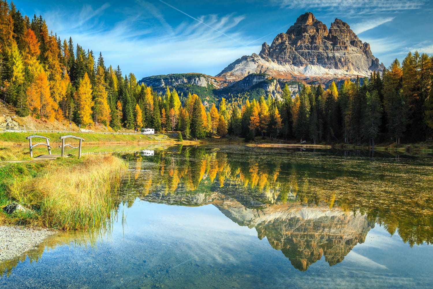 Majestic autumn landscape,alpine glacier lake and yellow pine trees, Antorno lake with famous Tre Cime di Lavaredo peaks in background, Dolomites, Italy, Europe