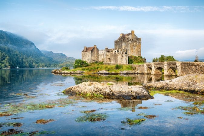 Early morning sunlight over Eilean Donan Castle at Kyle of Lochalsh in the Western Highlands of Scotland