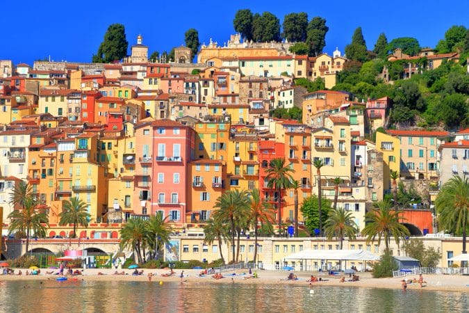Historical buildings on sunny hillside by the sea, Menton, French Riviera, France