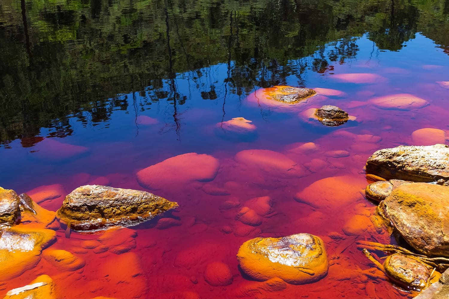 Stones in Rio Tinto river. The rocks can make infinite number of abstract compositions. Red tinted river by copper on the ground. Water used in life study for life detection in Mars