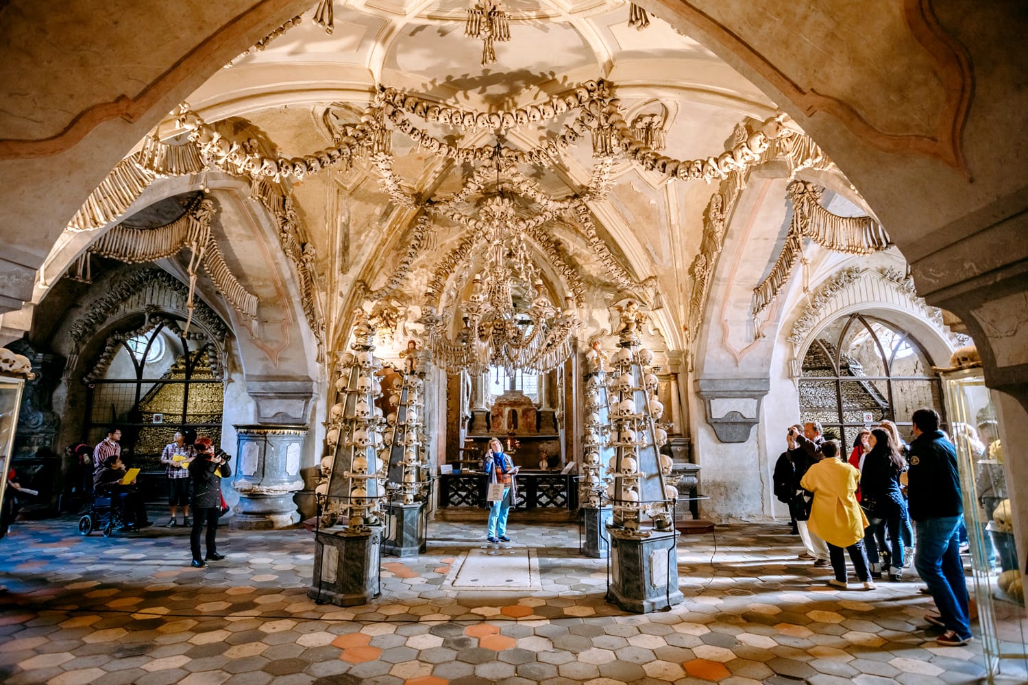 People visiting the ossuary in Sedlec Kostnice. Ossuary Contain Skeletons about 50,000 People, Whose Bones Been Arranged To Form Decorations For Chapel.