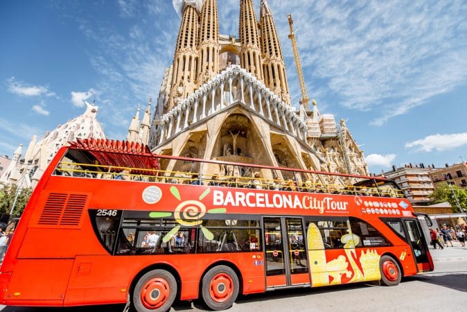Tourist bus near the famous Sagrada Familia roman catholic church in Barcelona, designed by catalan architect Antoni Gaudi