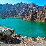 Hatta Dam Green Lake between mountains in Dubai, United Arab Emirates