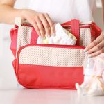 Woman packing a diaper bag backpack