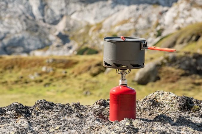 Backpacking stove with mountain background