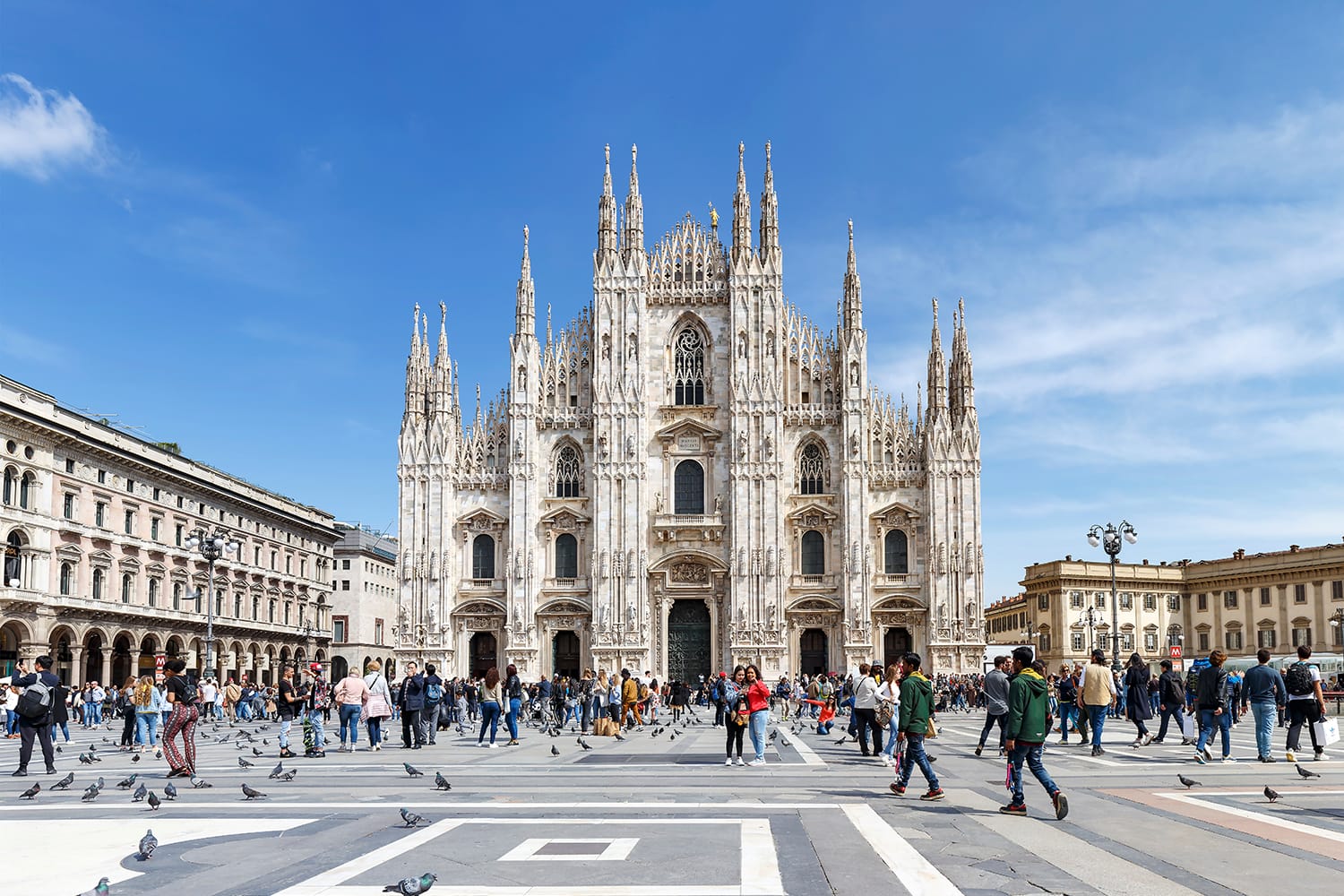 Duomo Milan with tourists and blue sky