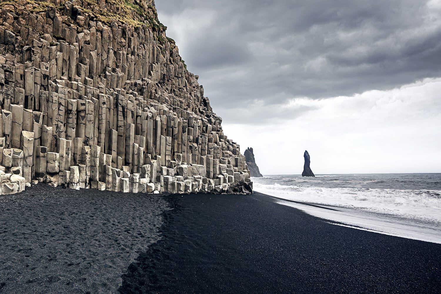 The black sand beach of Reynisfjara and the mount Reynisfjall from the Dyrholaey promontory in the southern coast of Iceland.