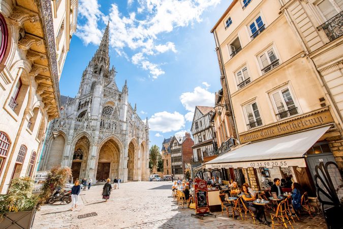 Street view with saint Maclou gothic cathedral during the sunny day in Rouen, France