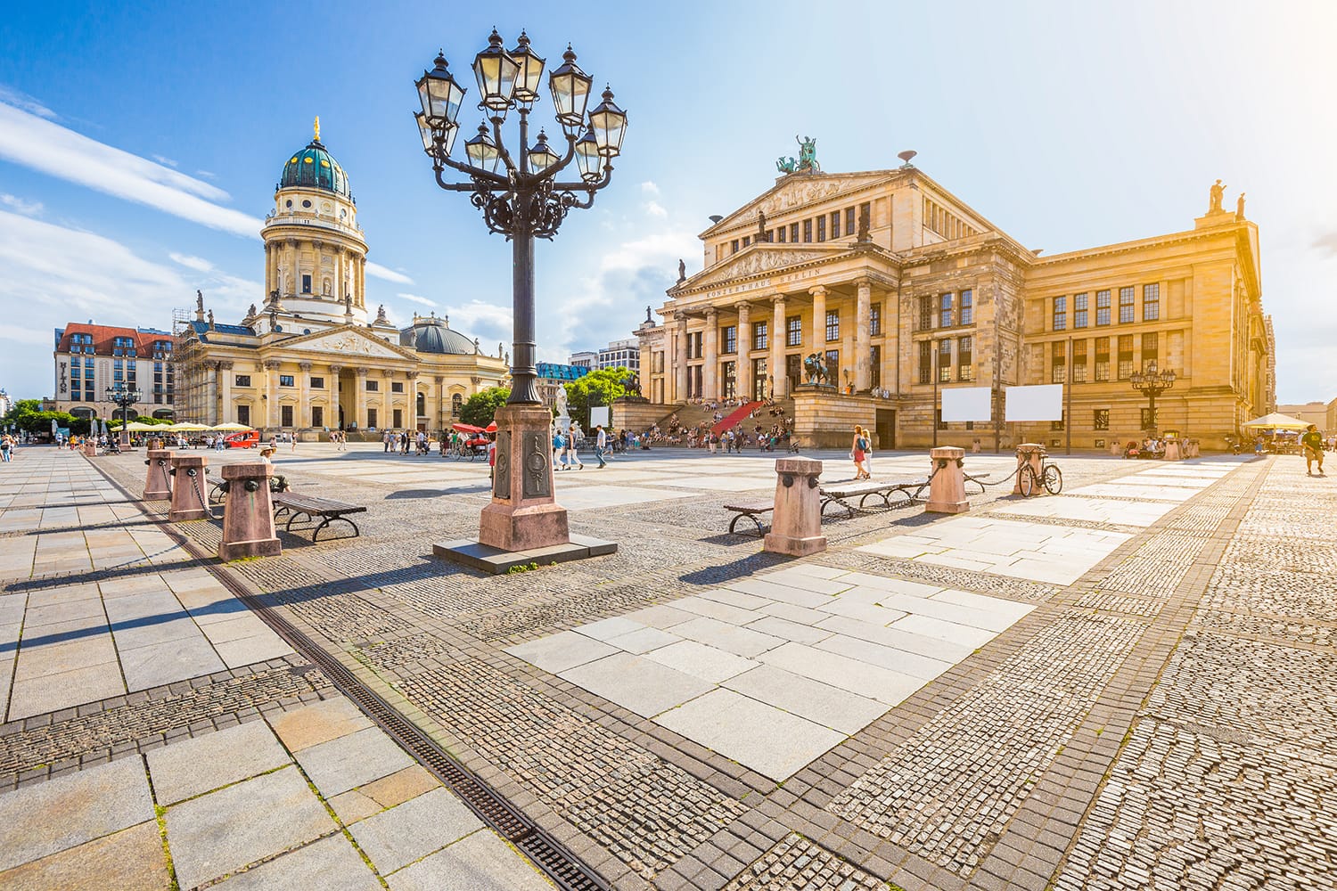 Panoramic view of famous Gendarmenmarkt square with Berlin Concert Hall and German Cathedral in golden evening light at sunset with blue sky and clouds in summer, Berlin Mitte district, Germany