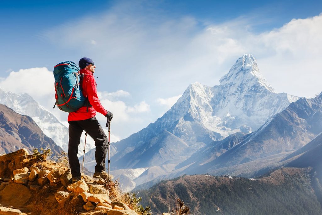 Active hiker with backpack enjoying the view. Himalayas. Nepal