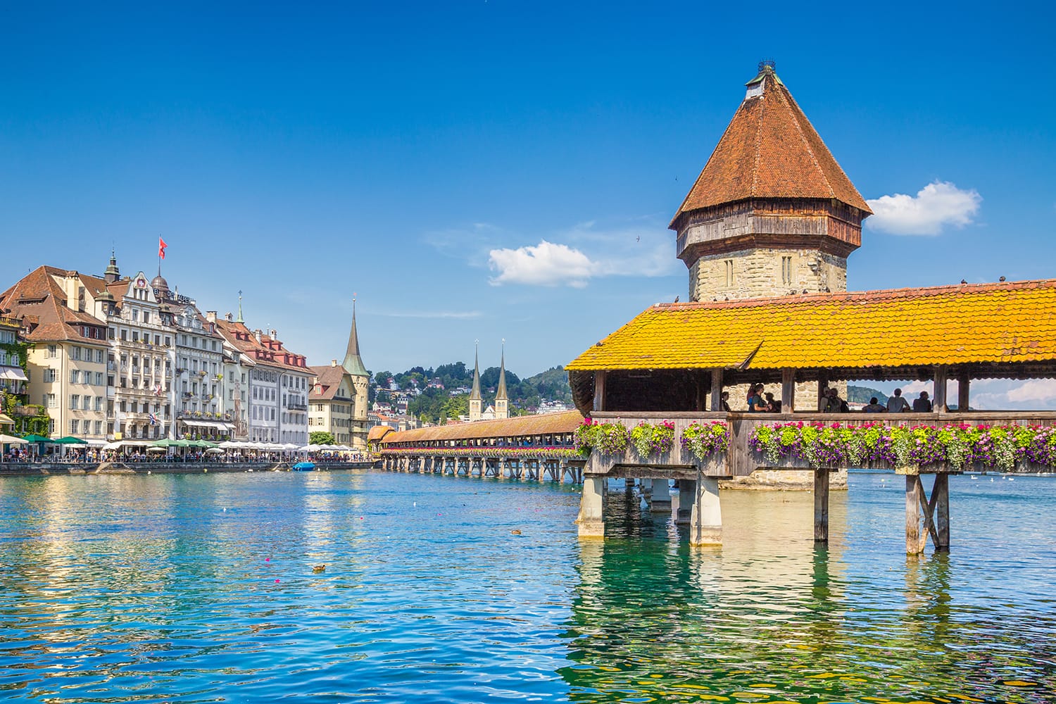 Famous Chapel Bridge in the historic city center of Lucerne, the city's symbol and one of Switzerland's main tourist attractions and views on a sunny day in summer, Canton of Lucerne, Switzerland