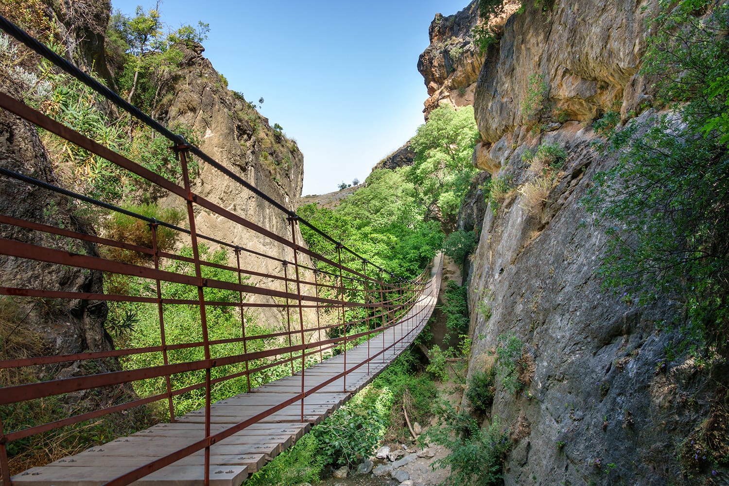 Wide angle view of rope bridge over a canyon in Cahorros, Granada, Andalusia, Spain