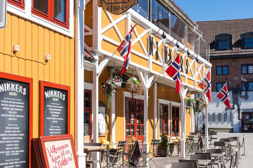 Colorful wooden building with Norwegian flags in Lillehammer, Norway