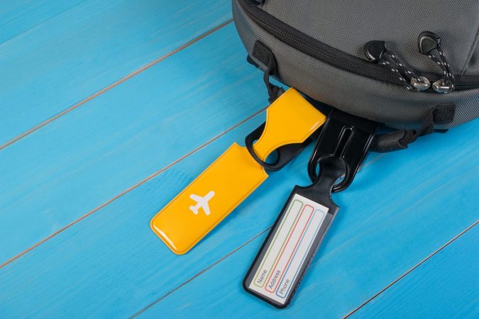 Close up of blank luggage tag label on suitcase or bag