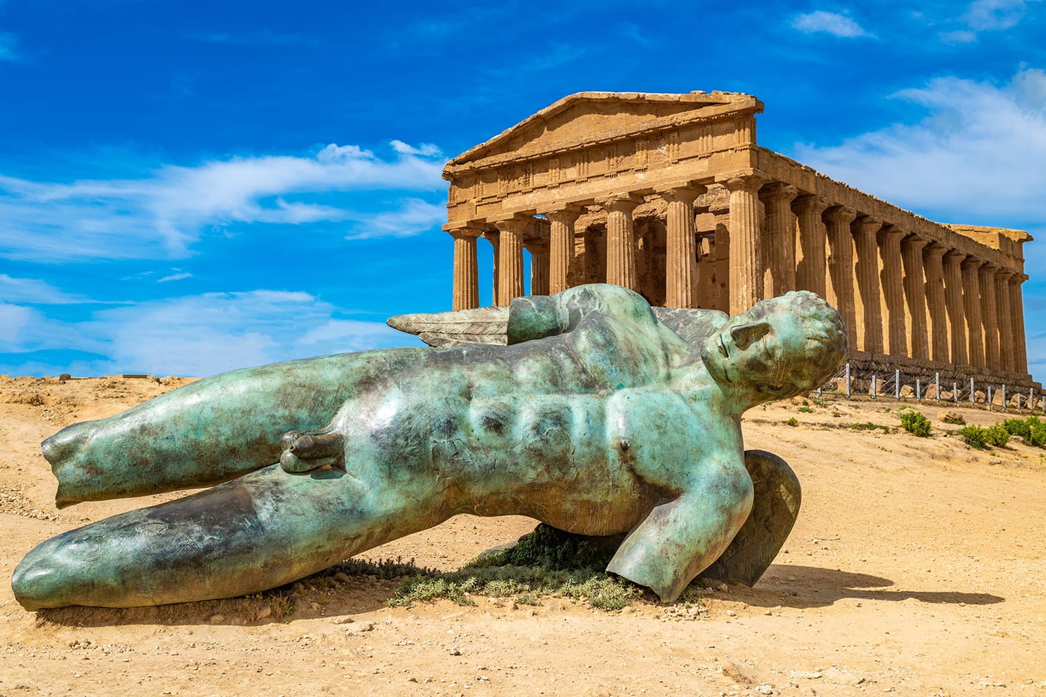 Temple of Concordia and the statue of Fallen Icarus, in the Valley of the Temples, Agrigento, Sicily, Italy