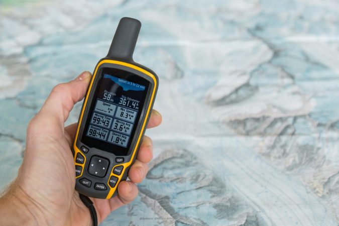 Handheld outdoor GPS and a hiking map