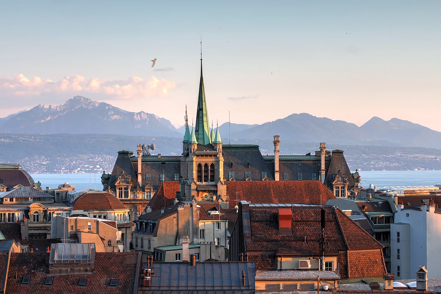 Skyline of Lausanne, Switzerland as seen from the Cathedral hill at sunset zoomed-in on the tower of St-Francois Church.