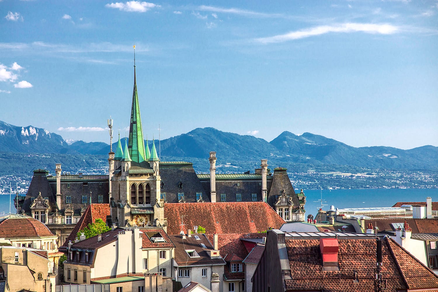 View of the Swiss city of Lausanne on Lake Geneva and the Alps