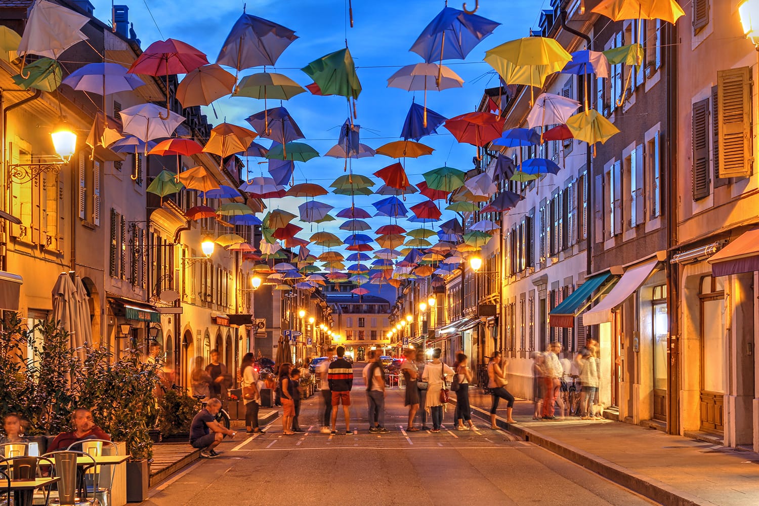 Night scene in Carouge, Geneva, Switzerland along Rue Saint Joseph covered temporarly by colorful umbrellas