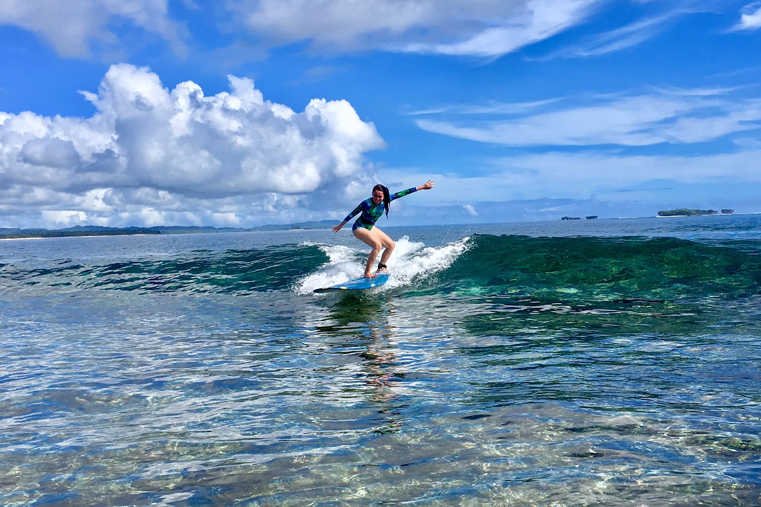 Woman surfing in Siargao, Philippines