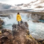 Tourist overlooking waterfall on Golden Circle in Iceland