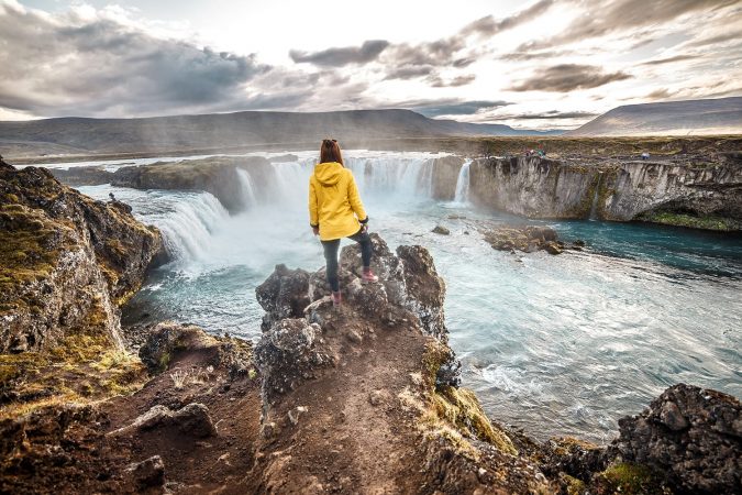 Tourist overlooking waterfall on Golden Circle in Iceland
