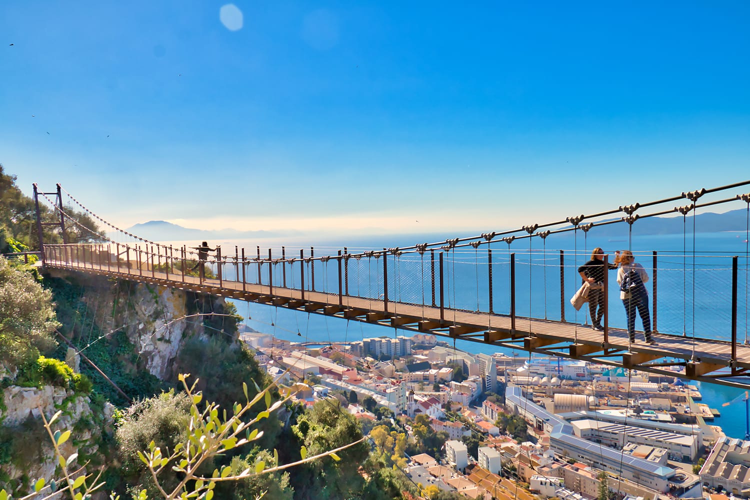 Tourists in Gibraltar crossing the Windsor suspension bridge