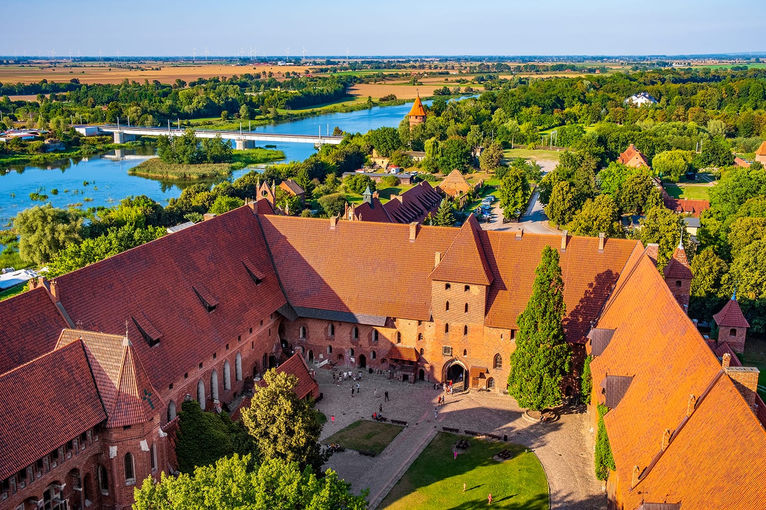 Aerial panoramic view of the inner courtyard with the gate tower in the Middle Castle part of the medieval Teutonic Order Castle by the Nogat river in Malbork