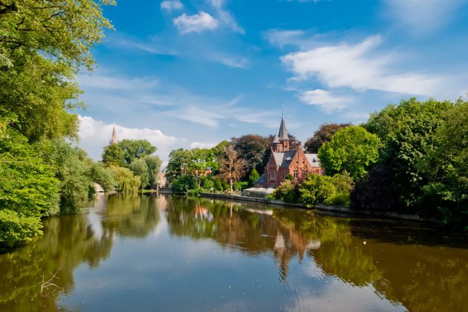 Minnewater castle at the Lake of Love in Bruges, Belgium