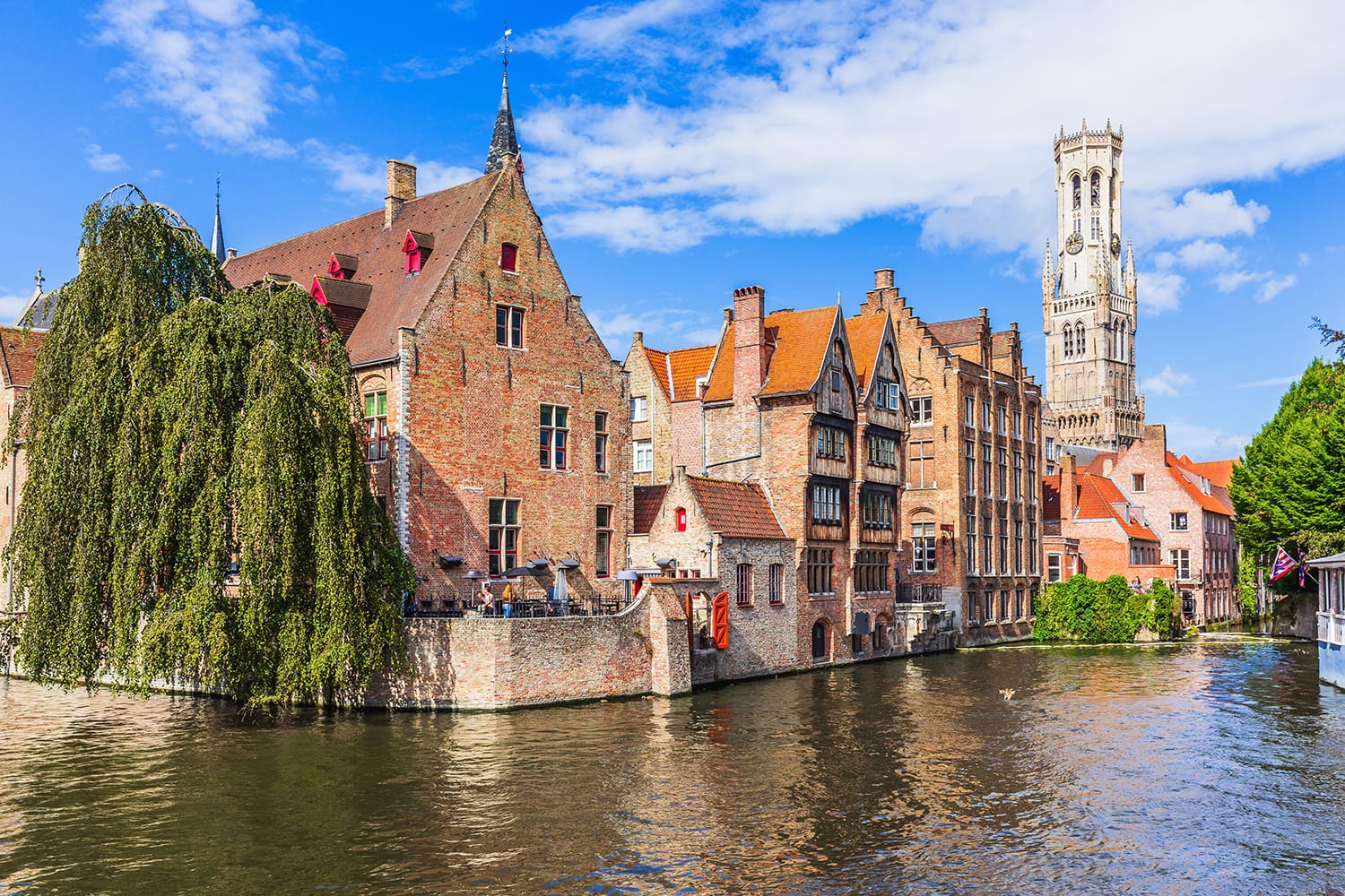 The Rozenhoedkaai canal in Bruges with the Belfry in the background.