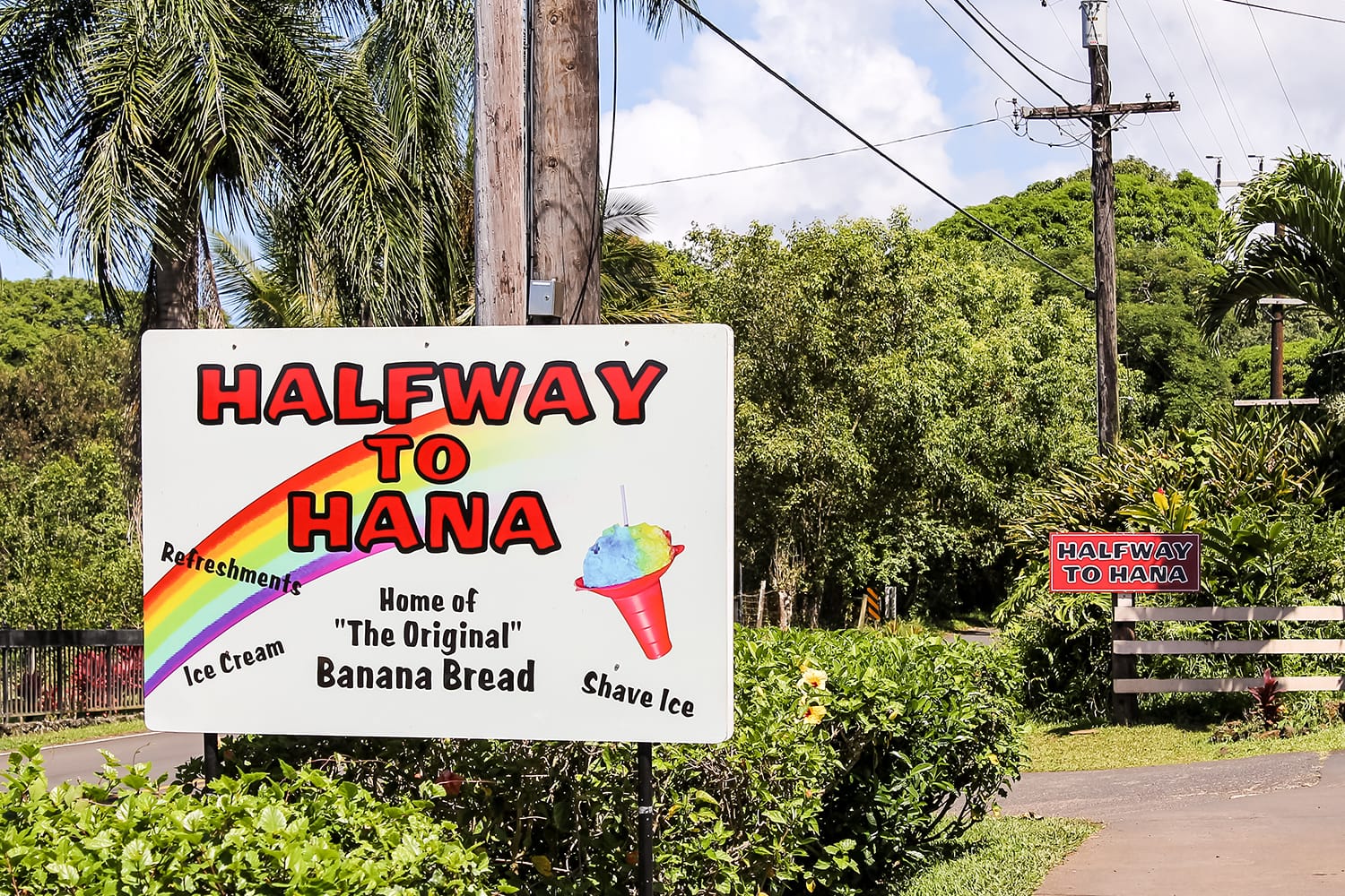 Halfway to Hana sign on the yard of a little shop on Road to Hana, Maui, Hawaii