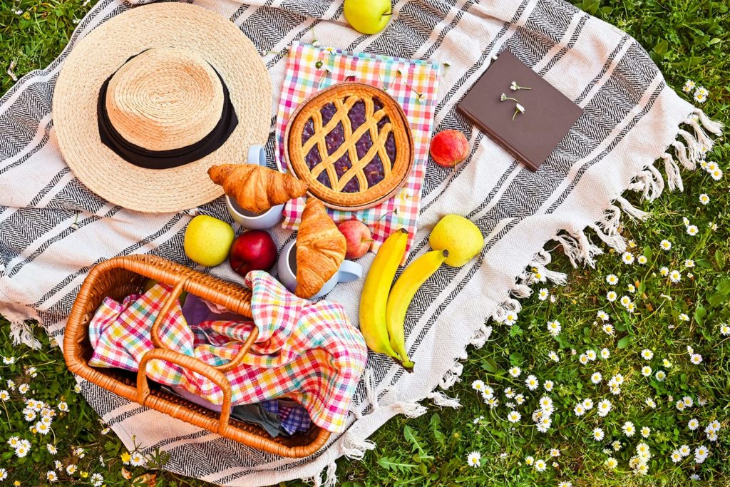 Picnic basket on the green grass in the park