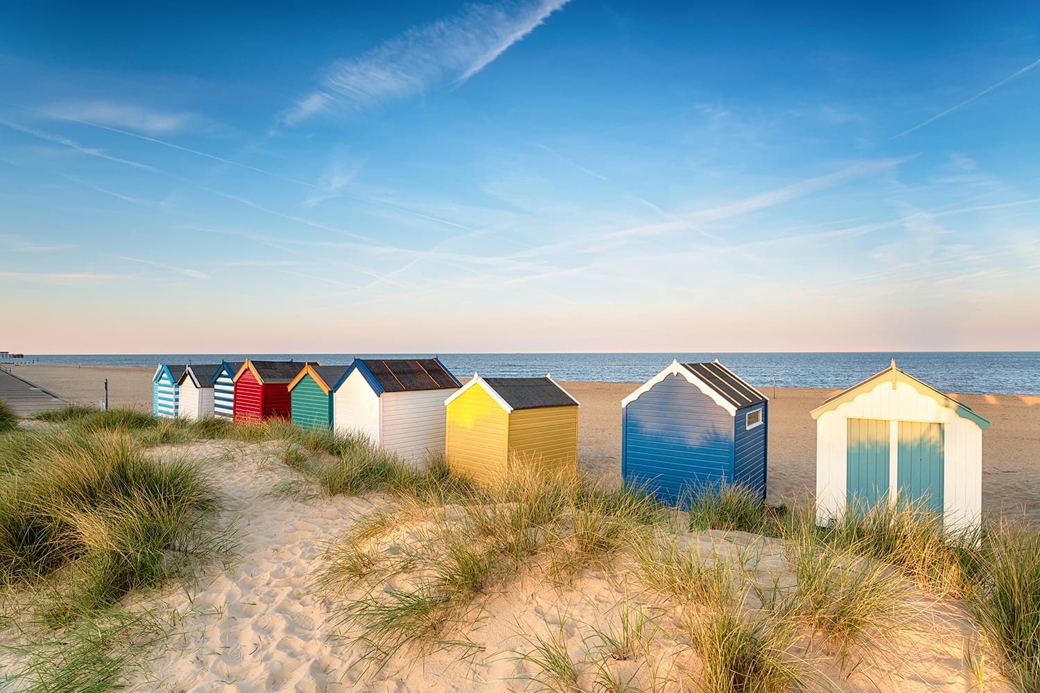 Beach huts in sand dunes at Southwold on the Suffolk coast, UK
