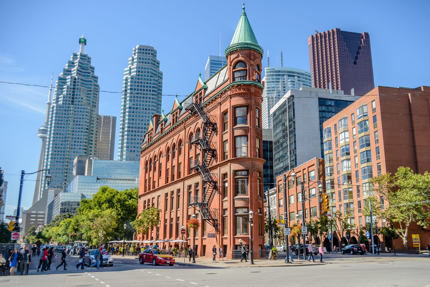 People walk in the Gooderham building area, a Victorian historic building surrounded by the financial district in Toronto, Canada