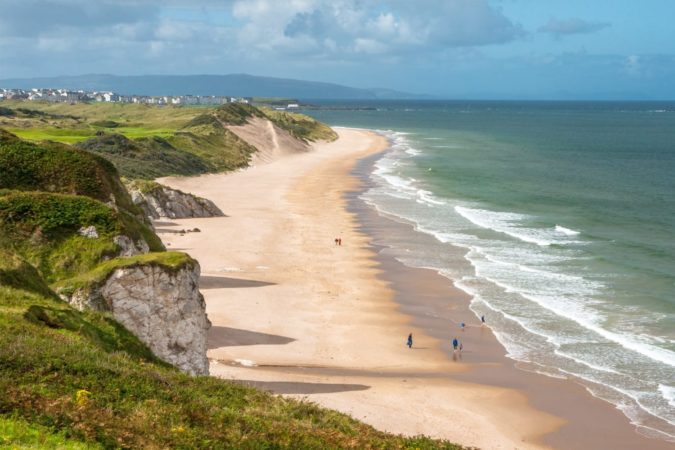 Panoramic view of people walking on Whiterocks Beach Portrush, Northern Ireland, UK