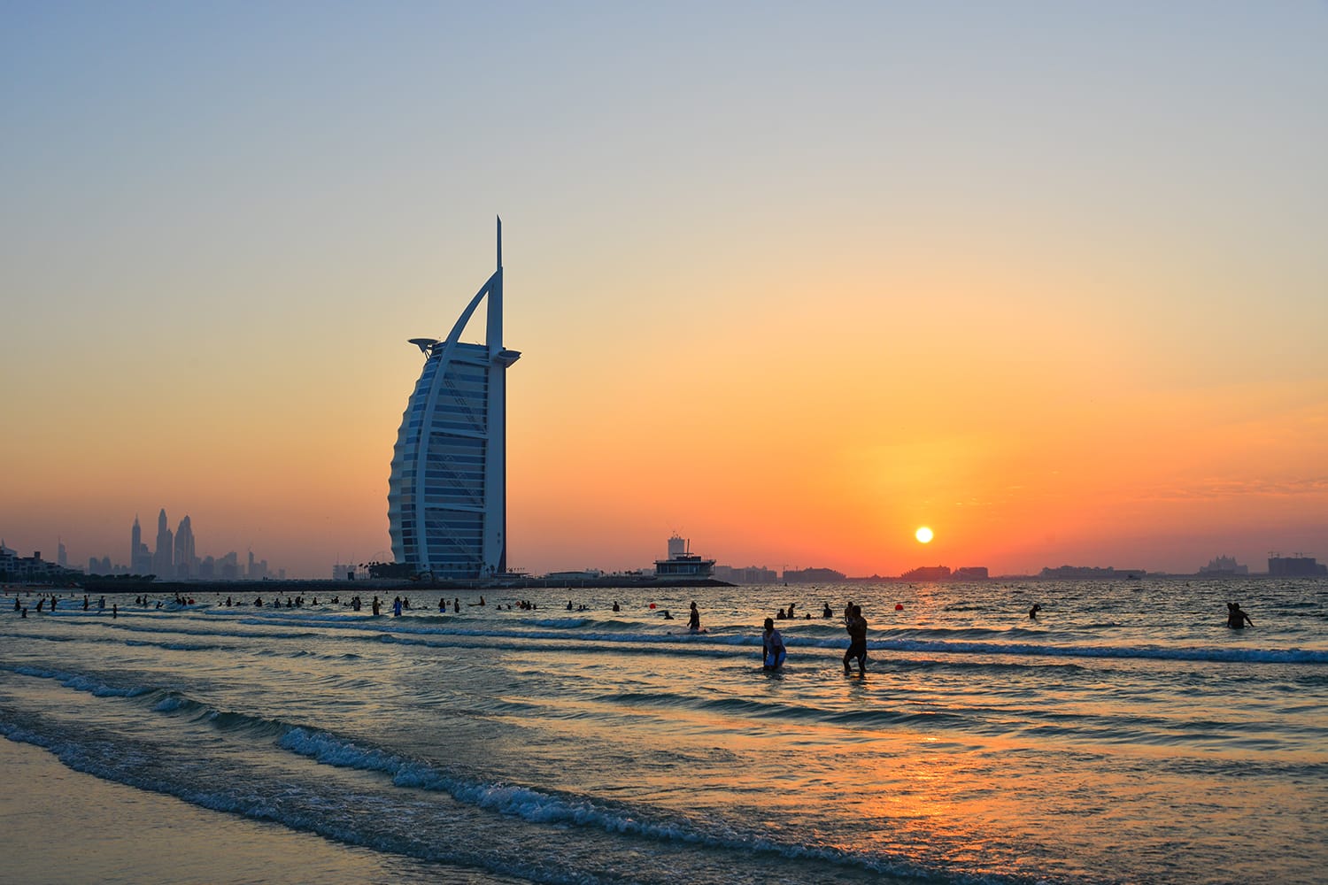 The Burj Al Arab Hotel and beach at sunset.
