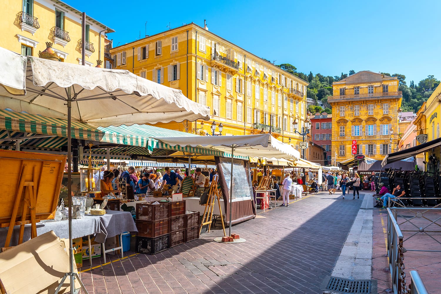 People enjoying a summer day at the outdoor market at Cours Saleya in Old Town Vieux, Nice, on the French Riviera.