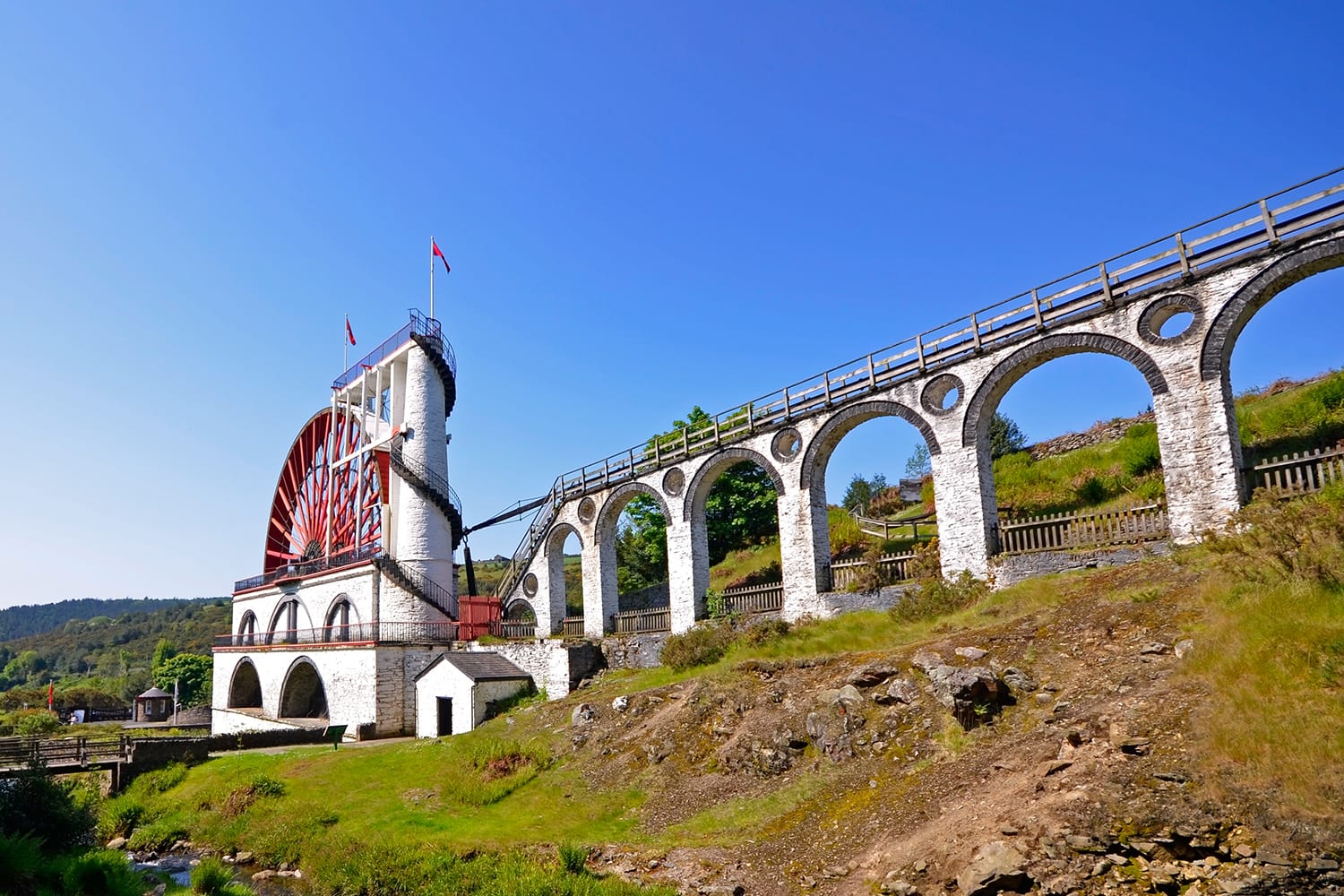 The Great Laxey Wheel with viaduct on sunny day - Isle of Man