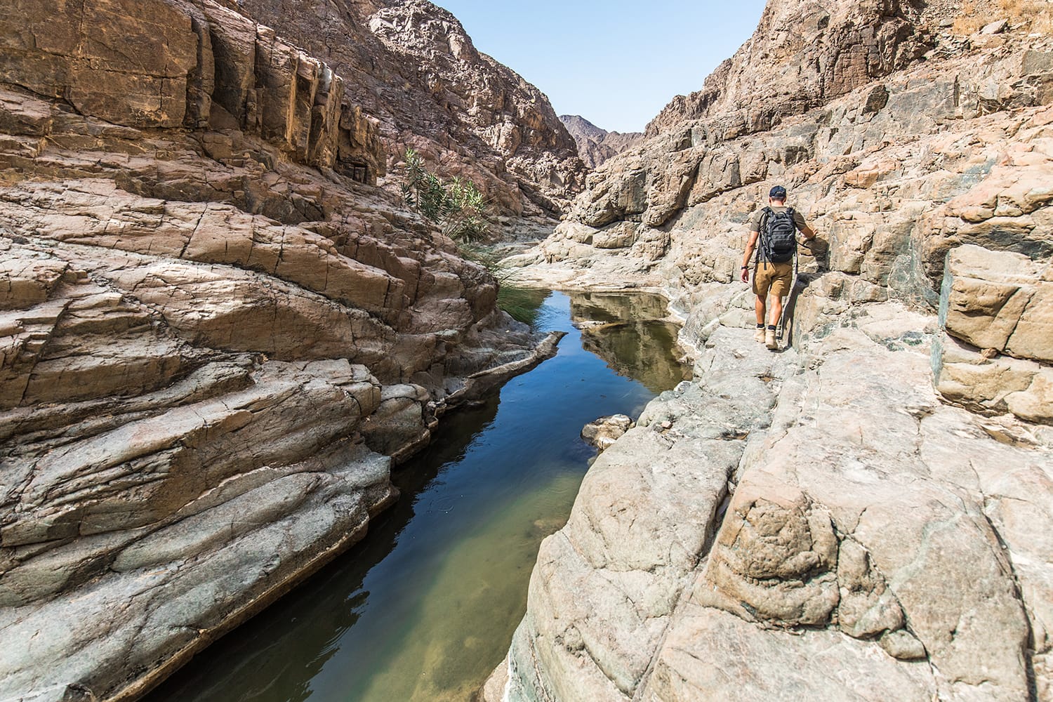 A man hiking through Wadi Shawka in Ras Al Khaimah, UAE