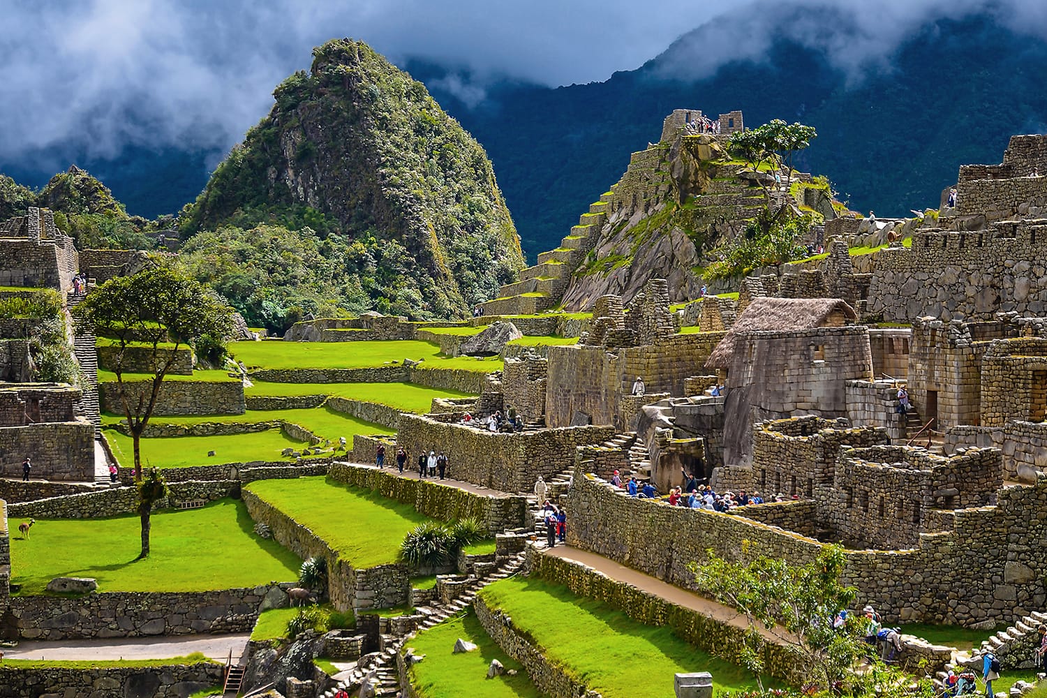 People visiting the ancient Inca city of Machu Picchu in Peru